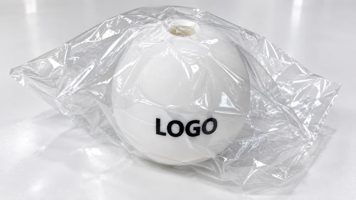 A custom-logo single ice ball mold inside individual clear packaging